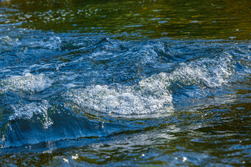 flow of water and spray from a stone