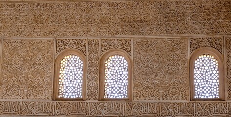 Details of the Moorish calligraphy wall decoration in one of the palaces the Alhambra, Granada