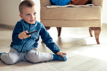Happy little boy using remote control