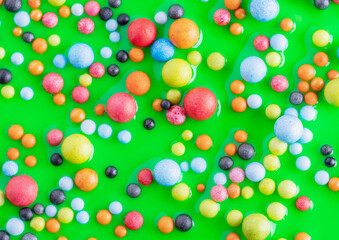 Colorful balls in pink paint, abstract colorful background. Background with colorful balls in different sizes. Sphere of balls on pastel color.