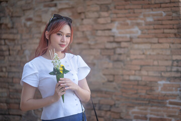 Pretty Asian tourists woman wearing beautiful hand-woven clothes dyed with indigo and mud-fermented...