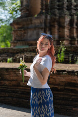Pretty Asian tourist woman wearing beautiful Modern Thai traditional dress costumes in the ancient Wat Chet Yot Temple (Wat Jed Yod) an Old seven-pagoda Buddhist temple Chiang Mai, Thailand