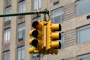 Traffic light signal in the city. American style yellow traffic light in New York City. Traffic in...