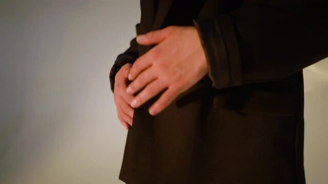 Brunette business girl in black lingerie and a business black jacket with a beautiful athletic figure in pantyhose, close-up of legs with a booty