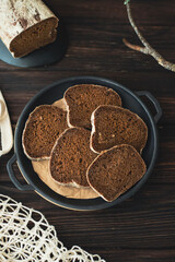 Slices of sliced black bread are laid out on a plate