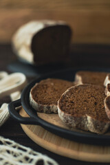 Slices of sliced black bread are laid out on a plate