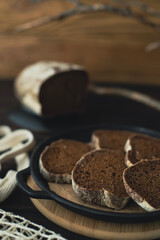 Slices of sliced black bread are laid out on a plate