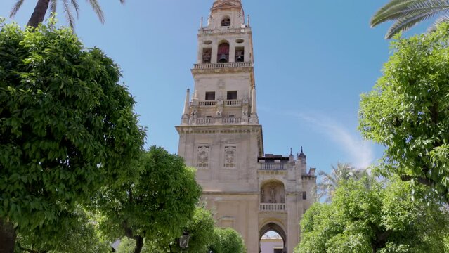 a close tilt up shot of torre campanario bell tower at the mosque-cathedral of cordoba, spain