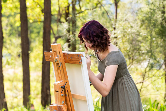 Young australian painter working on artwork outdoors