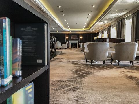 Luxurious elegant bar, lounge or coffee shop in cozy living room interior design with sofas, arm chairs and loungers onboard classic cruiseship cruise ship liner