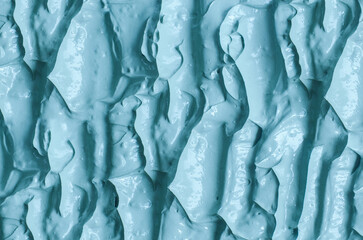 Blue bentonite facial clay (alginate mask, face cream, body wrap) texture close up, selective focus. Abstract background with brush strokes.