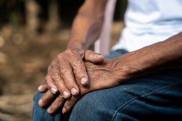 Fototapeta premium Close up of elderly oldman hands on wooden table.