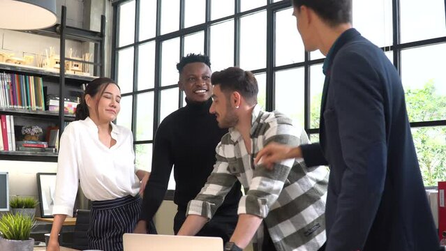 group of happy diversity business people meeting and discussion to close-up on table in office. young caucasian boss talking to african american and asian worker. Leadership briefing team friendly