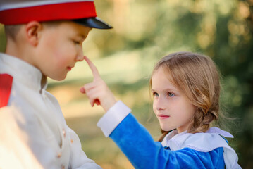 A beautiful love story. The girl touched the boy's nose with her finger. Boy and girl in love....