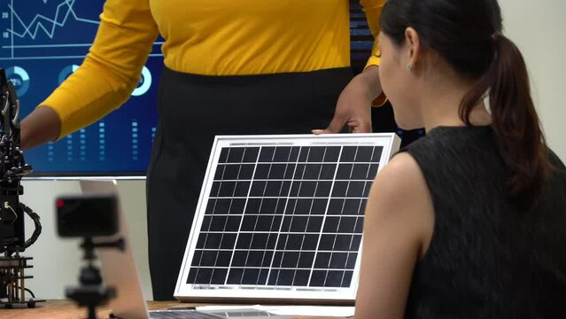 group of diversity Engineer testing and Presents Innovative Robot Arm and solar call panel in meeting room. multi ethnic teamwork Developers of student Scientists and Advanced Robotics Technology
