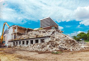 Process of demolition of old building dismantling. Excavator breaking ol house. Destruction of...