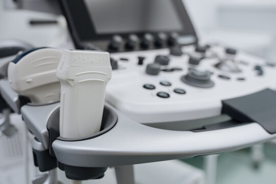 Close-up of an ultrasound scanner against the background of a modern ultrasound machine.