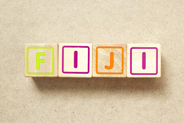 Wooden alphabet letter block in word fiji on wood background