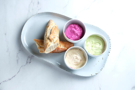 Bread on a ceramic dish with dips