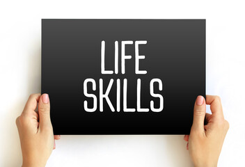Life skills - abilities for adaptive and positive behaviour that enable humans to deal effectively with the challenges of life, text concept on card