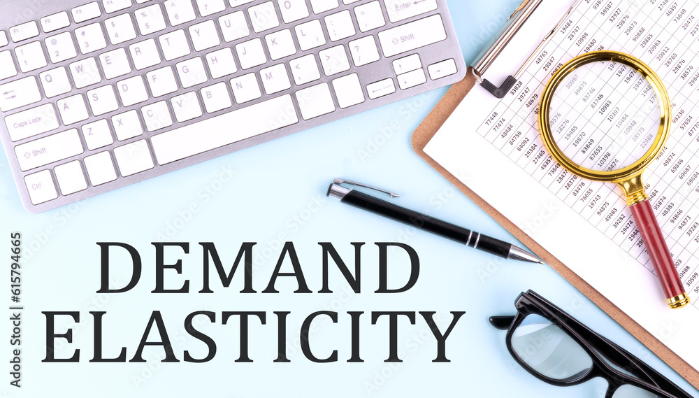 Poster demand elasticity text on blue background with keyboard and clipboard, business concept
