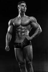 Fototapeta na wymiar Bodybuilder showing off his perfect low fat body without clothes in studio