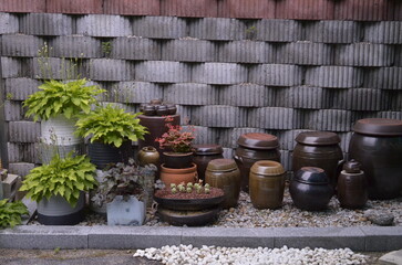 Korea traditional pots with organized bricks background, small pots for fermented food