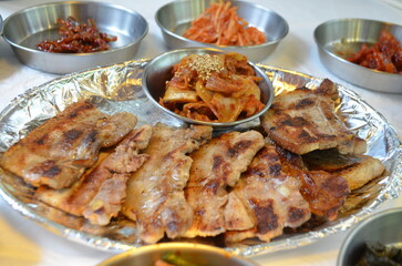 Korea grilled pork with grilled Kimchi, with several Korea traditional side dishes