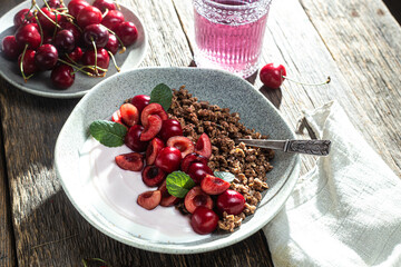 Granola with yogurt and cherries in a bowl
