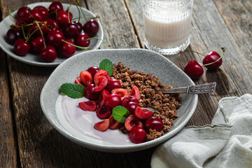 Granola with yogurt and cherries in a bowl
