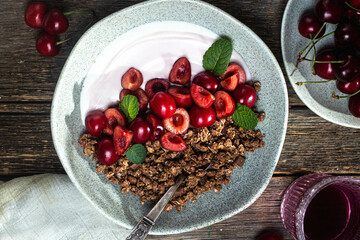 Granola with yogurt and cherries in a bowl
