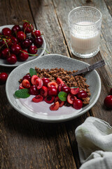 Granola with yogurt and cherries in a bowl
