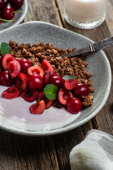 Granola with yogurt and cherries in a bowl
