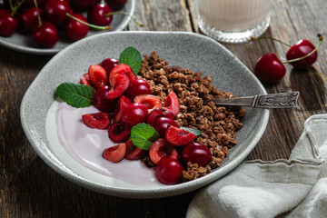 Granola with yogurt and cherries in a bowl
