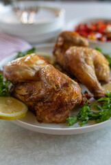 Oven baked half chicken on a dinner table