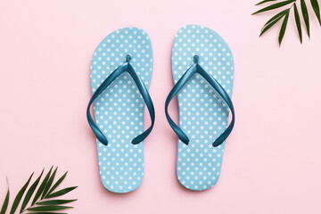 Flat lay composition with flip flops and seashell on colored background. Space for text top view