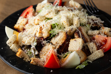 Caesar Salad on plate on black table food