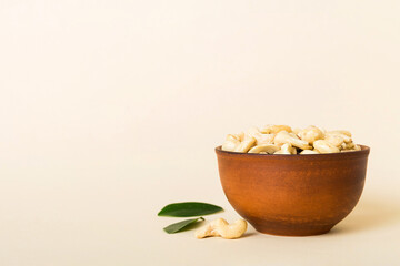 cashew nuts in wooden bowl on table background. top view. Space for text Healthy food