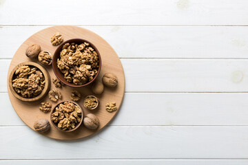 Fresh healthy walnuts in bowl on colored table background. Top view Healthy eating bertholletia concept. Super foods