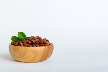 Fresh healthy peanuts in bowl on colored table background. Top view Healthy eating bertholletia concept. Super foods