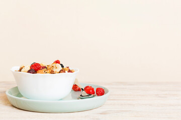 Cooking a wholesome breakfast. Granola with Various dried fruits and nuts in a bowl. The concept of a healthy dessert. Flat lay, top view with copy space