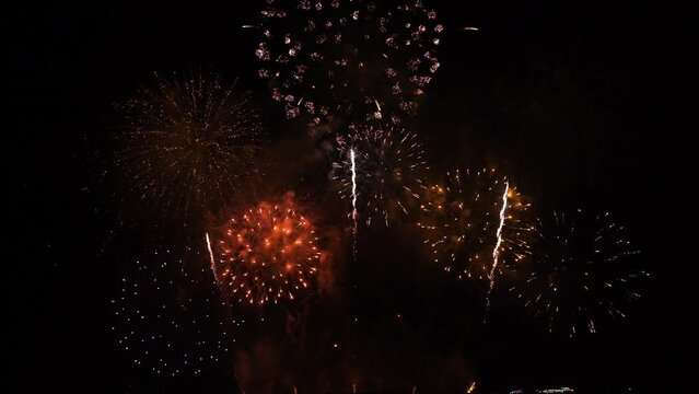 Real fireworks background. Firework Display,  abstract blur of real golden shining fireworks lights at night sky. glowing fireworks show. Firework  Explosive Material. New year's eve fireworks 