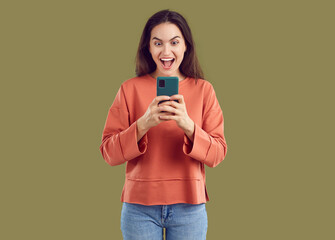 Woman winner in euphoria looks at screen of her mobile phone where she sees message about winning....