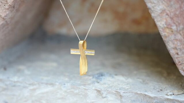 Gold baptismal cross on a chain