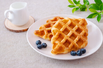 Croffle or croissant waffle with blueberries on plate