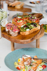 French sandwiches with ham tomatoes, avocado and microgreens. Catering in the office. Table with canapes and various snacks served at a banquet.