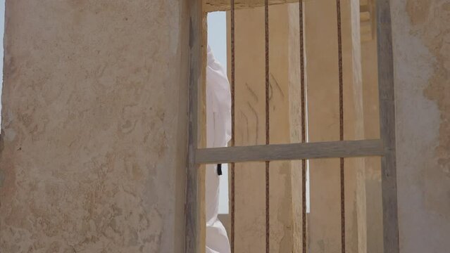 Qatari Man With Traditional Clothes At Al Jumail Village At Qatar
