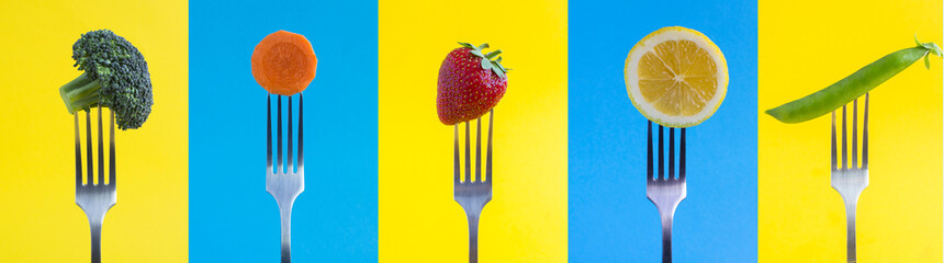 Collage. Vegetable, fruit and berry stabbed on a silver fork on the colored background. Close-up.