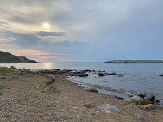 Kalekoy lighthouse and beach view at sunset of Gokceada Imbros island kalekoy harbor. Canakkale, Turkey