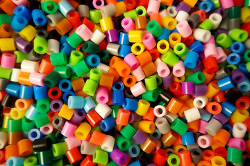 a lot of colorful plastic thermal beads for children 's development . view from above. multicolored background